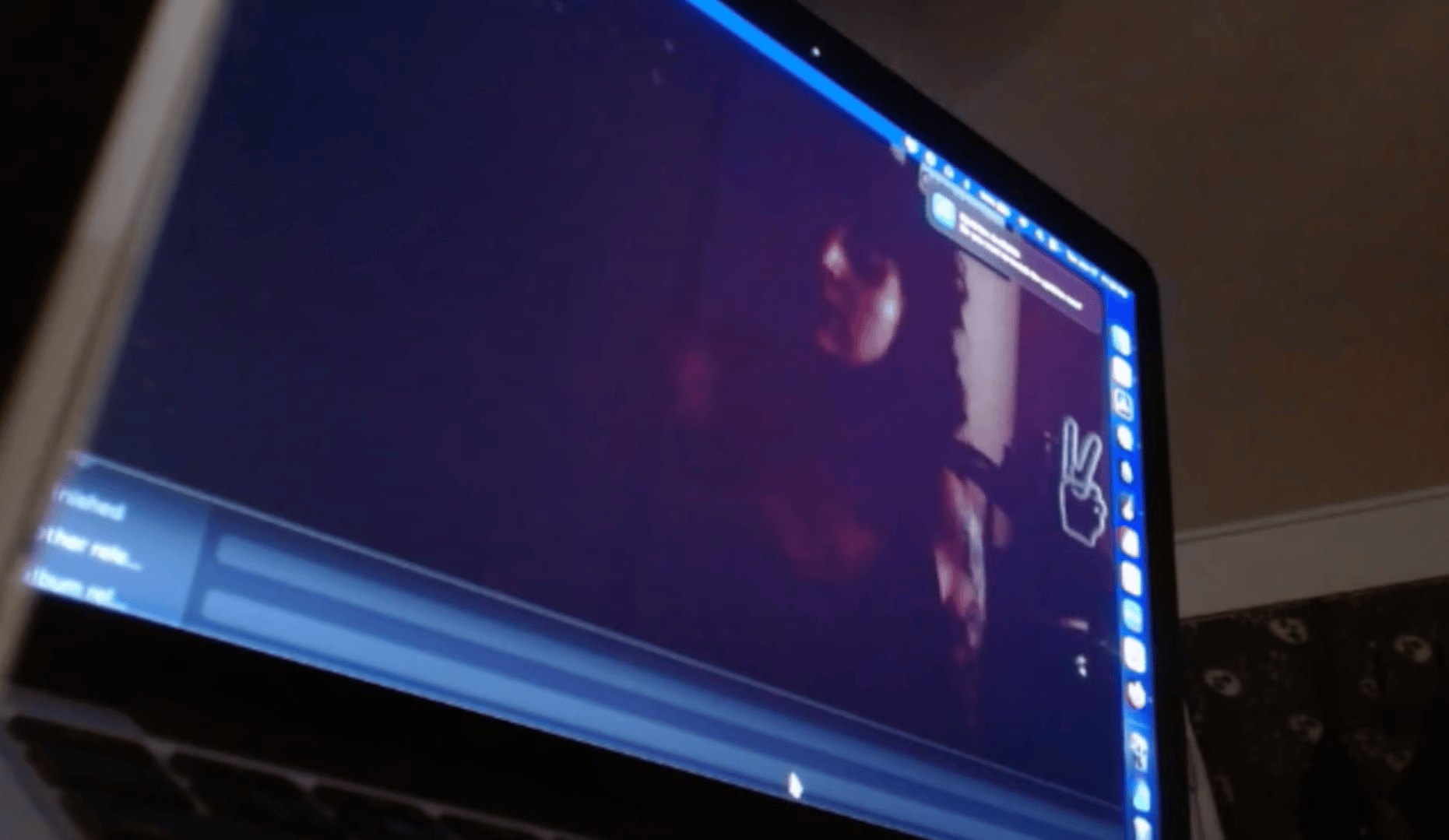 a macbook with a webcam feed of someone looking to the side