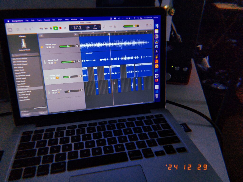 a disposable camera styled image of a macbook with a project called "hello" open in garageband